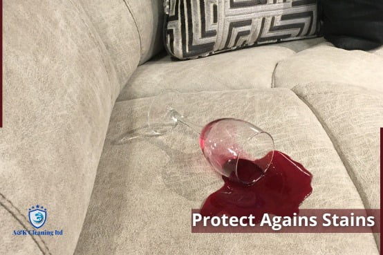 A glass of wine spilled on a cream sofa
